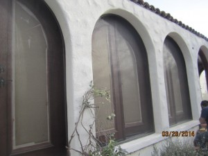 Studio City installation of arched screen panel for inswinging arched oak wood french doors