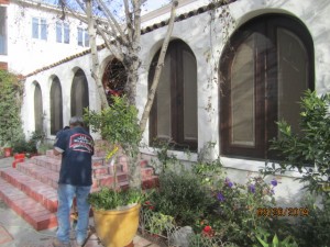 Studio City installation of arched screen panel for inswinging arched oak wood french doors